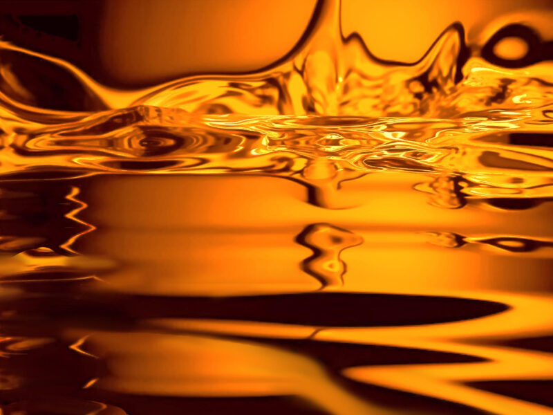 Golden diesel fuel swirling in abstract motion