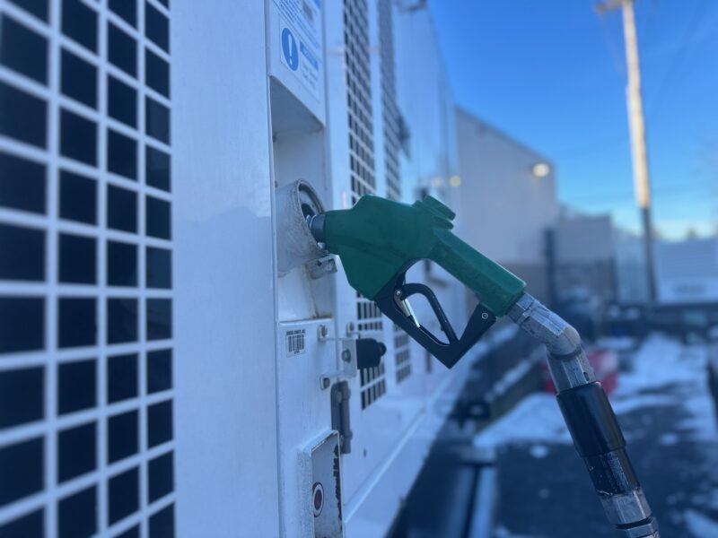 Green diesel nozzle fueling refrigerated trailer in Portland snow