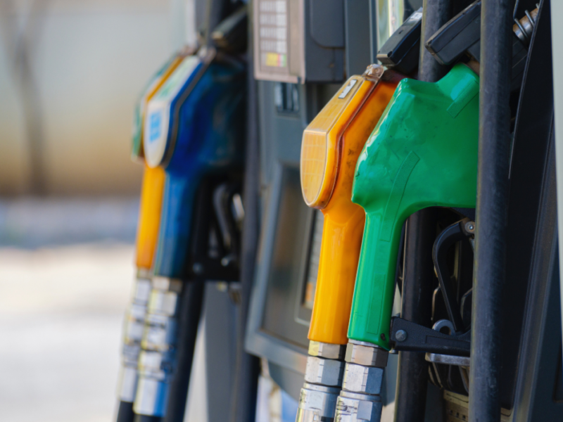 Close-up of green, yellow, and blue fuel nozzles at a diesel pump station