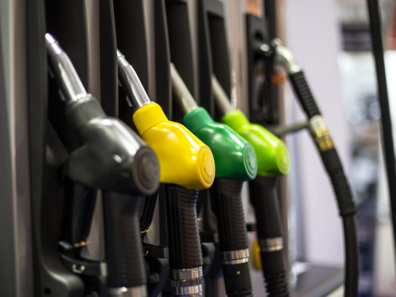 Fuel nozzles at a gas station in multiple colors
