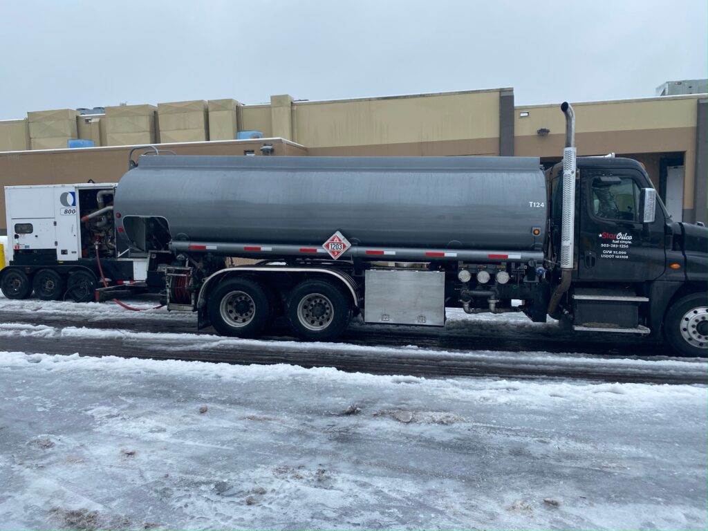 Star Oilco fuel tanker delivering diesel to refrigerated trailer during winter weather conditions