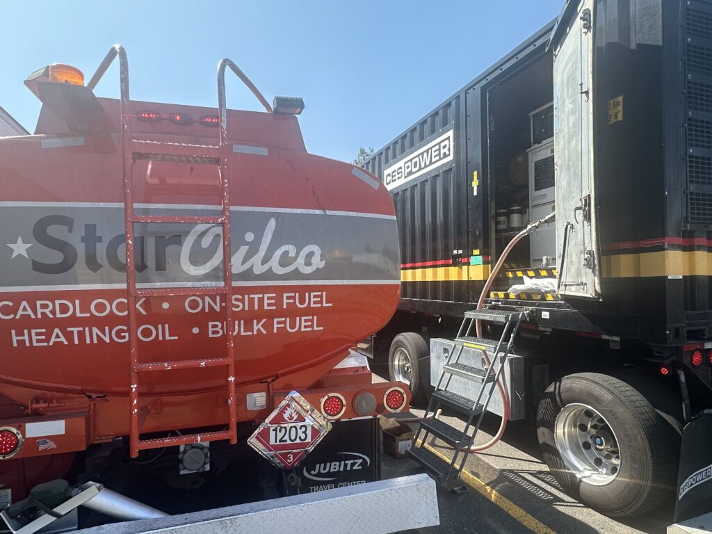 Star Oilco fuel tanker delivering diesel to a CES Power mobile generator unit in a commercial lot