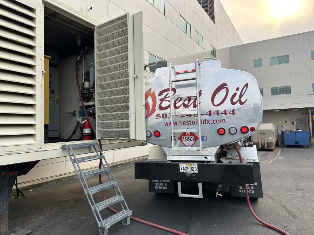 Best Oil diesel delivery truck refueling a commercial generator system at a large building