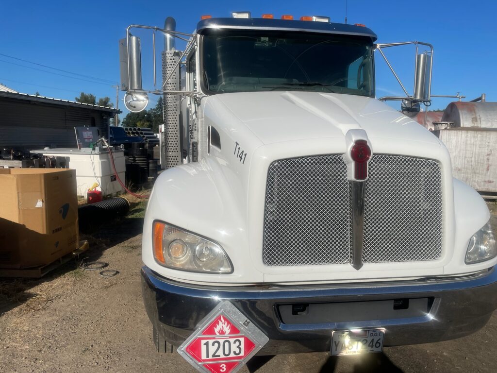 Star Oilco white fuel truck with flammable fuel placard parked at a fueling facility