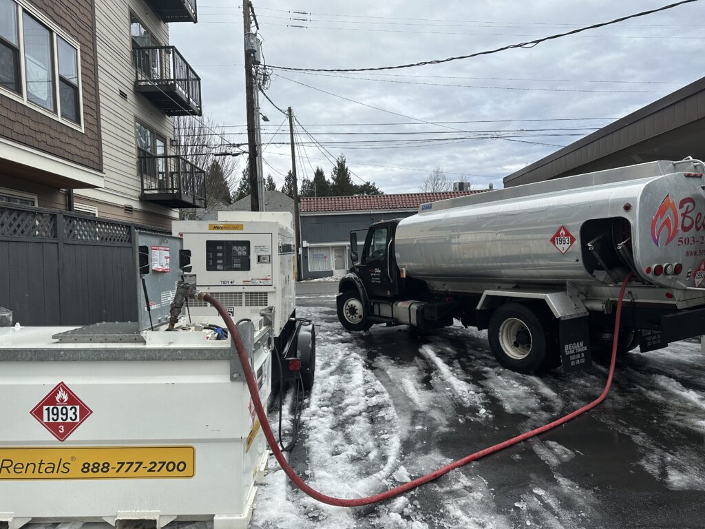 Star Oilco fuel truck delivering diesel to a rental generator during icy winter weather