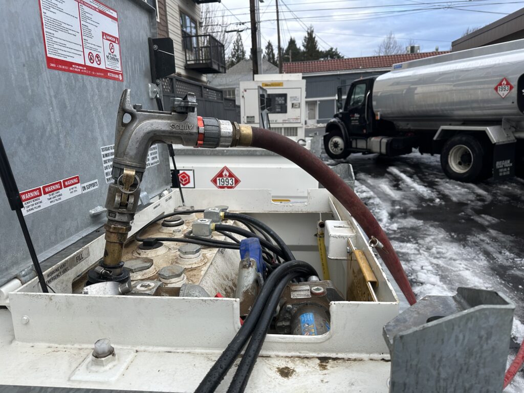 Star Oilco fuel truck delivering diesel to a rental generator during icy winter weather